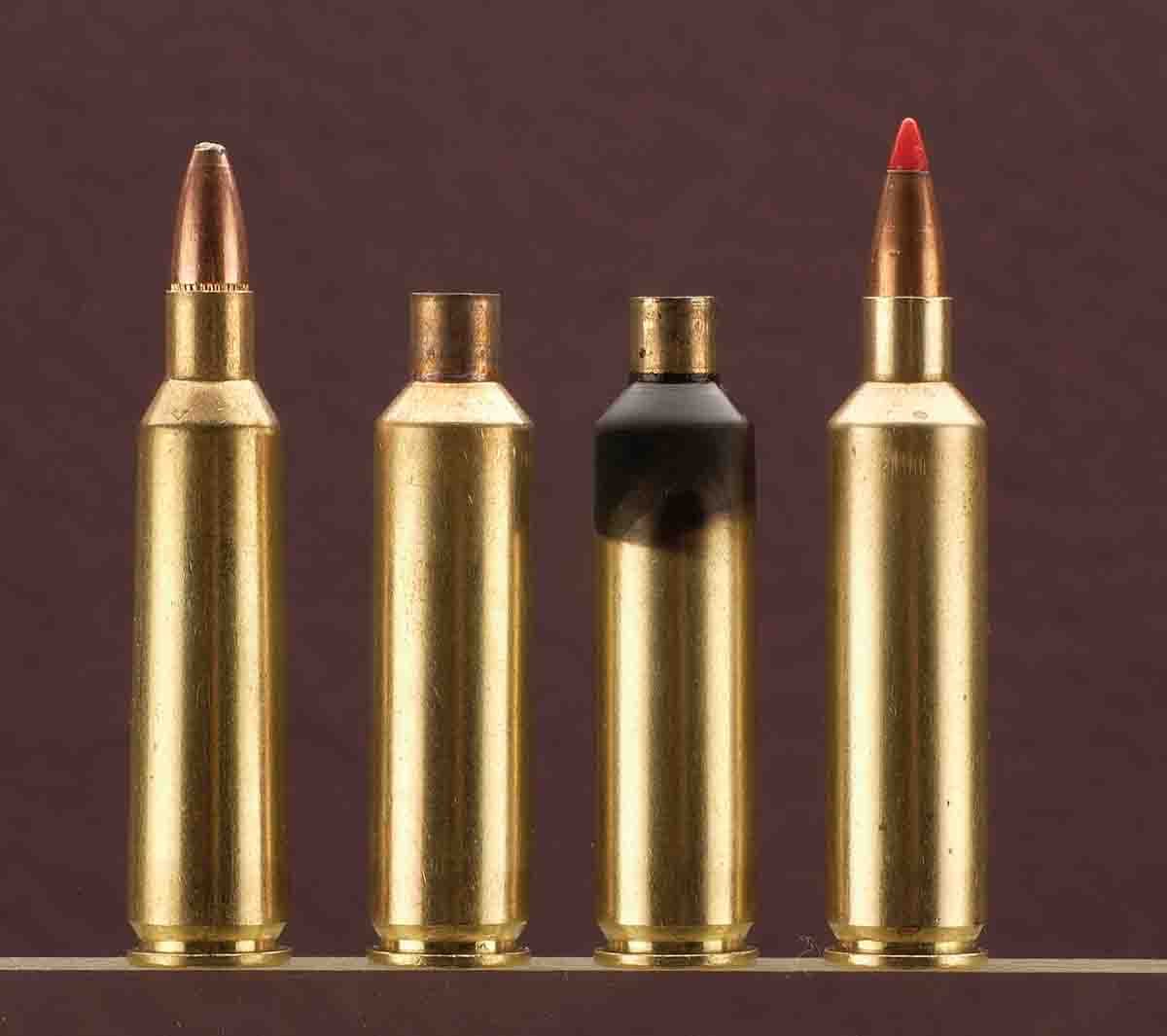 The first case is .22-250 Remington ammunition followed by the Improved case, a blackened case for die adjust­ment and the loaded  Improved cartridge.